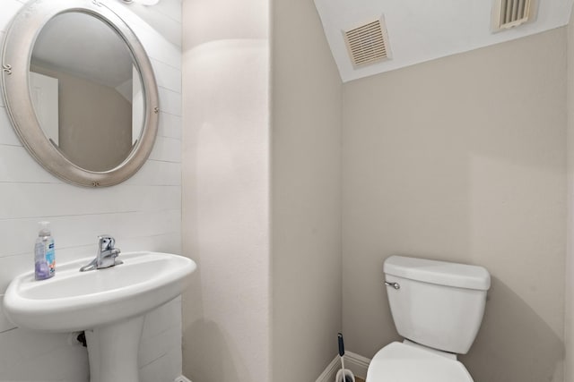 bathroom featuring toilet and visible vents