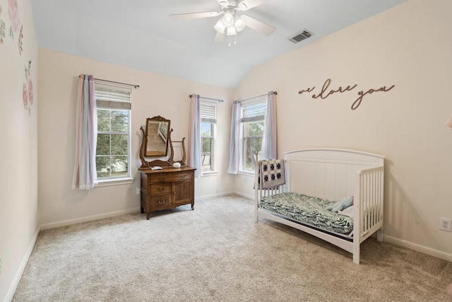 bedroom with lofted ceiling, carpet floors, visible vents, and baseboards