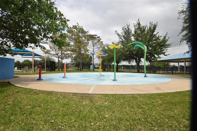 view of sport court featuring fence, playground community, and a yard