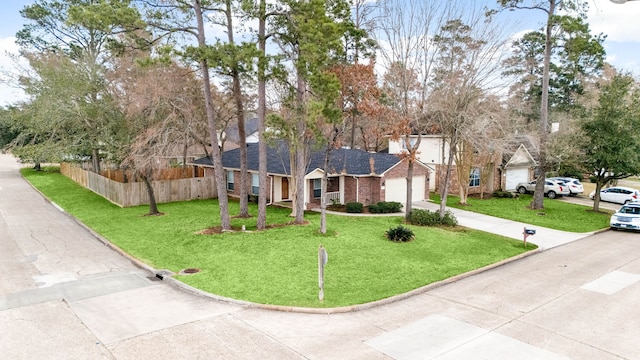 single story home featuring an attached garage, brick siding, a front yard, and fence