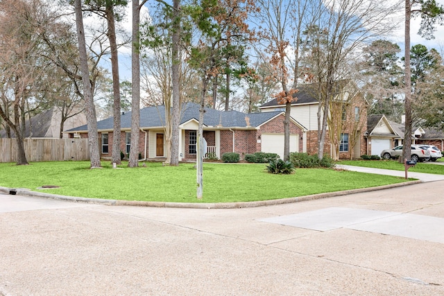 ranch-style house featuring brick siding, concrete driveway, an attached garage, fence, and a front yard