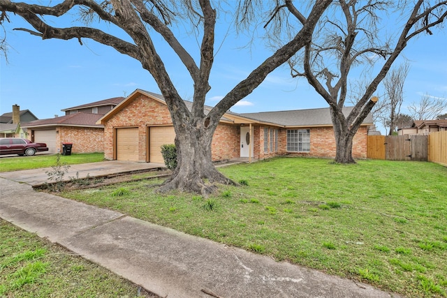 ranch-style home featuring an attached garage, brick siding, fence, driveway, and a front yard