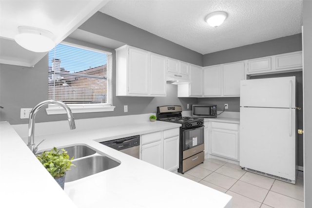 kitchen with white cabinets, appliances with stainless steel finishes, light countertops, under cabinet range hood, and a sink