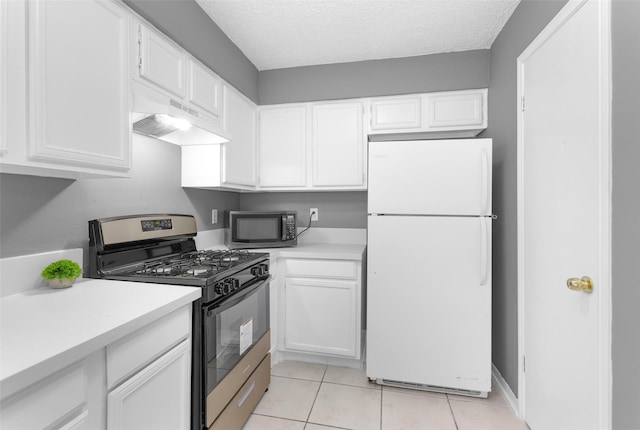 11330 Sunfish Ln, Houston, TX 77067 - kitchen with freestanding refrigerator, stainless steel range with gas cooktop, under cabinet range hood, white cabinets, and light countertops