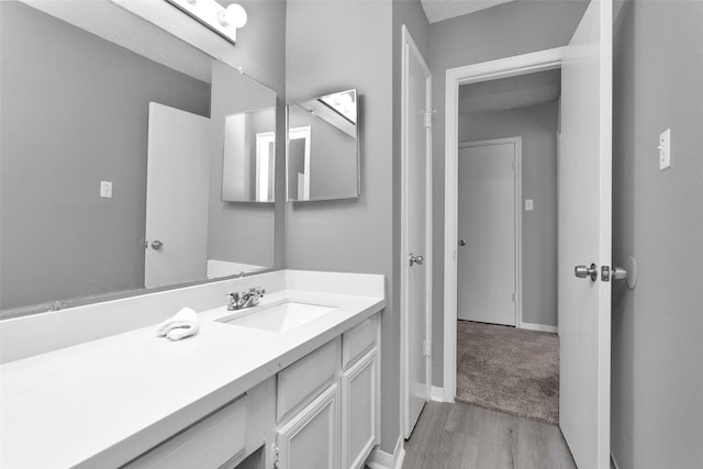 11330 Sunfish Ln, Houston, TX 77067 - bathroom with wood finished floors, vanity, and baseboards