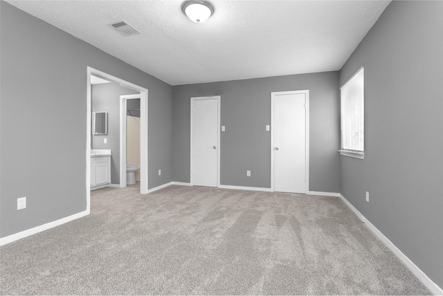 11330 Sunfish Ln, Houston, TX 77067 - unfurnished bedroom with light carpet, baseboards, a textured ceiling, and ensuite bath