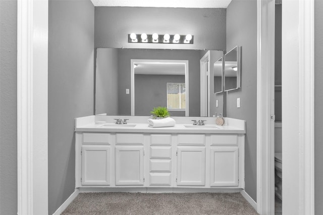 11330 Sunfish Ln, Houston, TX 77067 - bathroom featuring double vanity, toilet, and baseboards