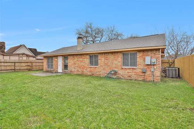 11330 Sunfish Ln, Houston, TX 77067 - rear view of house featuring brick siding, roof with shingles, a chimney, and central AC unit