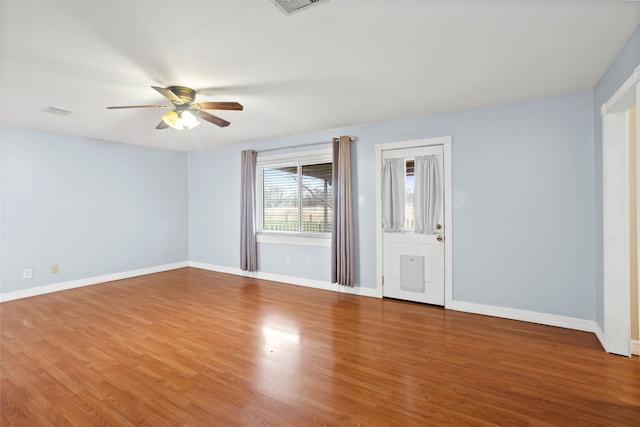 11707 Bowie Dr, La Porte, TX 77571 - spare room featuring a ceiling fan, visible vents, baseboards, and wood finished floors