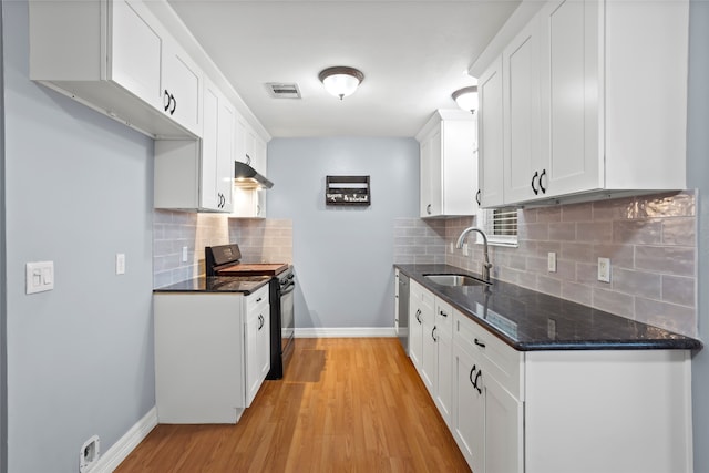 11707 Bowie Dr, La Porte, TX 77571 - kitchen with black electric range, visible vents, white cabinets, and a sink
