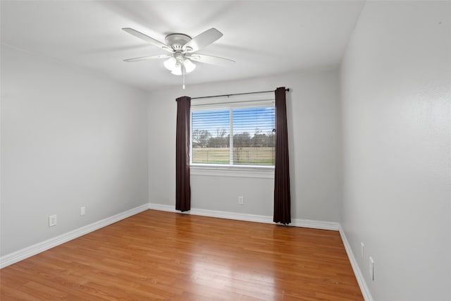 11707 Bowie Dr, La Porte, TX 77571 - unfurnished room with baseboards, ceiling fan, and light wood-style floors