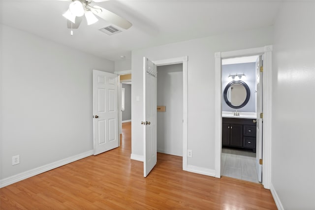 11707 Bowie Dr, La Porte, TX 77571 - unfurnished bedroom with baseboards, visible vents, a sink, and light wood finished floors
