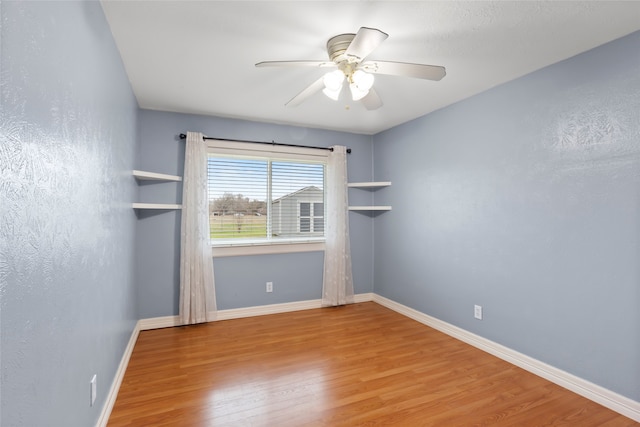 11707 Bowie Dr, La Porte, TX 77571 - unfurnished room with a ceiling fan, baseboards, and wood finished floors