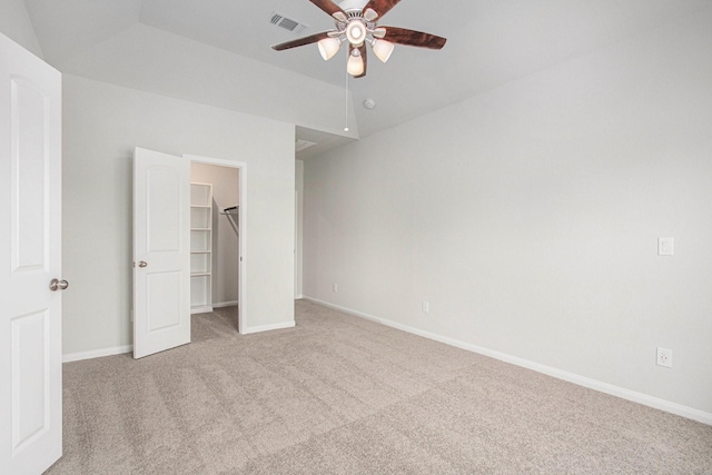 411 Wellshire Dr, West Columbia, TX 77486 - unfurnished bedroom featuring light colored carpet, a walk in closet, a closet, and a ceiling fan