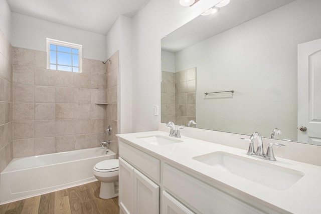 411 Wellshire Dr, West Columbia, TX 77486 - bathroom featuring wood finished floors, double vanity, and shower / washtub combination