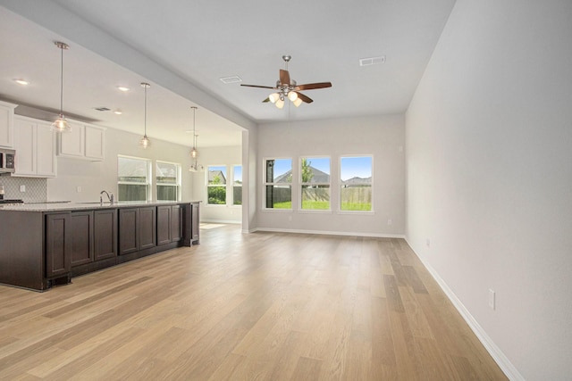 411 Wellshire Dr, West Columbia, TX 77486 - unfurnished living room featuring a ceiling fan, light wood-type flooring, and recessed lighting