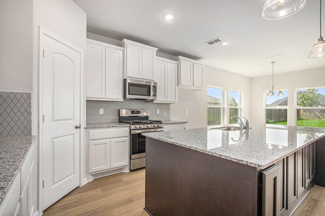 411 Wellshire Dr, West Columbia, TX 77486 - kitchen with appliances with stainless steel finishes, light wood-style floors, tasteful backsplash, plenty of natural light, and recessed lighting