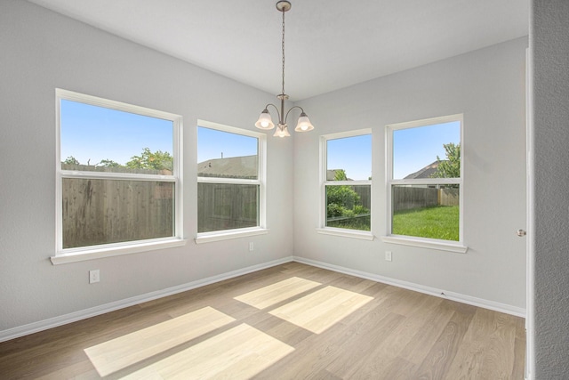 411 Wellshire Dr, West Columbia, TX 77486 - unfurnished room featuring wood finished floors and a chandelier