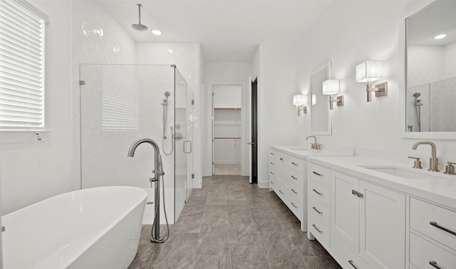 128 Luther Dean Ln, New Waverly, TX 77358 - full bath featuring a stall shower, a freestanding tub, double vanity, a spacious closet, and recessed lighting