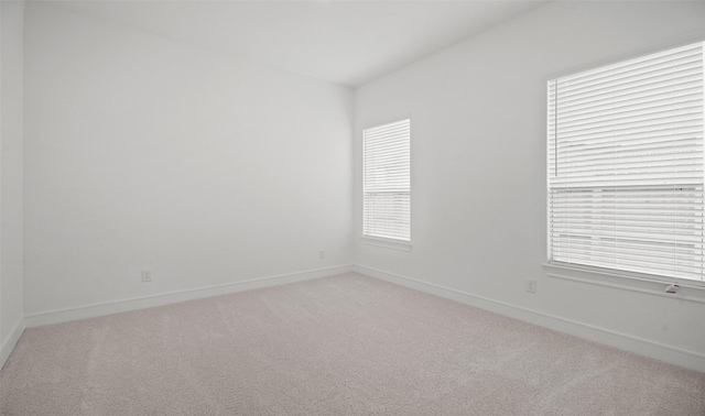 128 Luther Dean Ln, New Waverly, TX 77358 - unfurnished room featuring light colored carpet, baseboards, and plenty of natural light