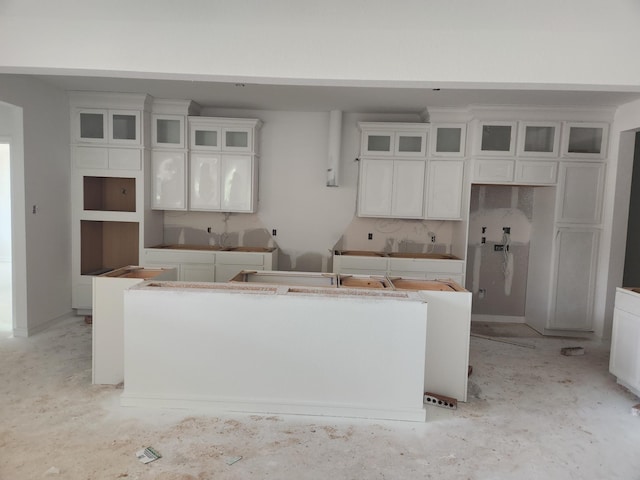 128 Luther Dean Ln, New Waverly, TX 77358 - kitchen with a center island, white cabinets, and glass insert cabinets