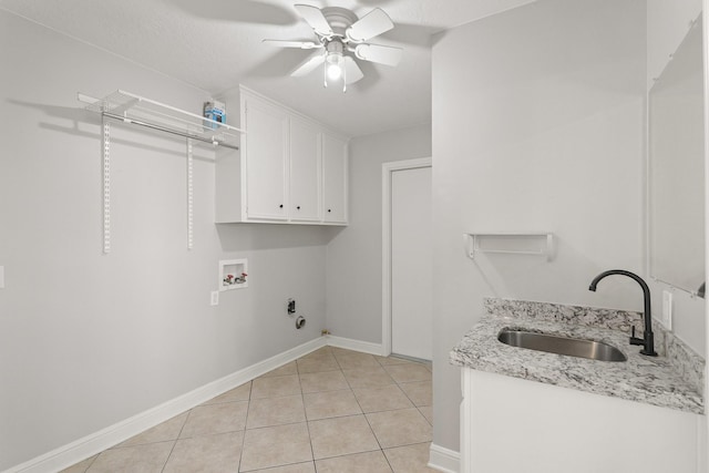 washroom featuring light tile patterned floors, ceiling fan, washer hookup, a sink, and cabinet space