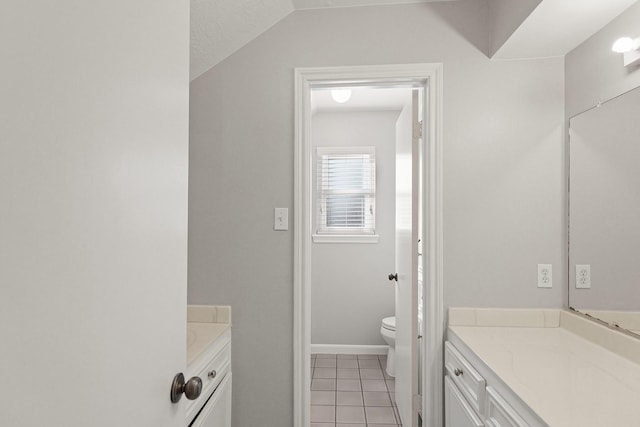 bathroom featuring toilet, vanity, and tile patterned floors