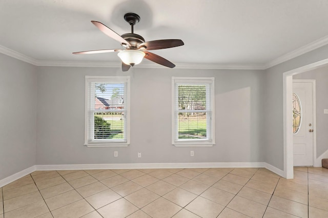 empty room with ornamental molding, a ceiling fan, baseboards, and light tile patterned floors