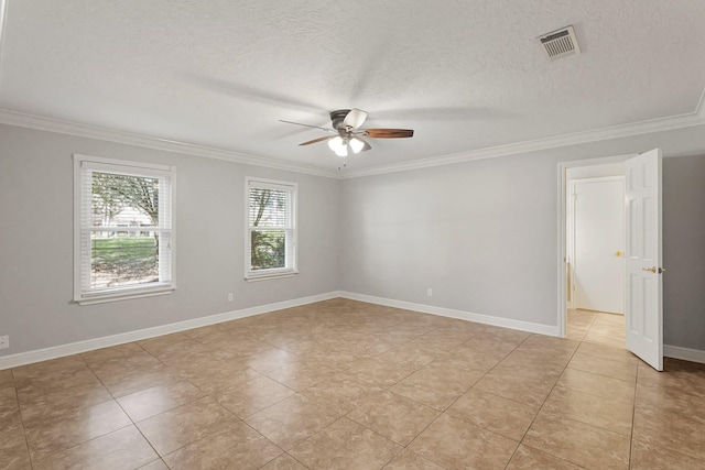 empty room with baseboards, visible vents, ceiling fan, ornamental molding, and a textured ceiling