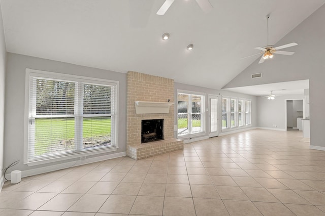 unfurnished living room with a ceiling fan, light tile patterned flooring, a fireplace, and baseboards