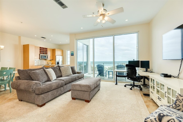 living room featuring a ceiling fan, recessed lighting, and visible vents