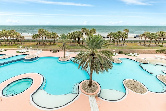 view of swimming pool featuring a water view