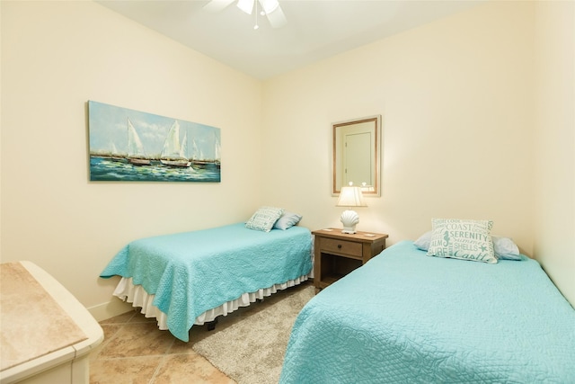 bedroom with a ceiling fan and baseboards