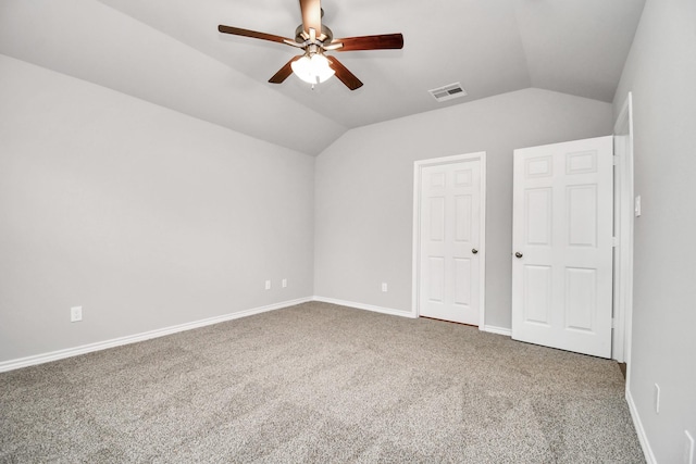 unfurnished bedroom featuring lofted ceiling, a ceiling fan, visible vents, baseboards, and carpet