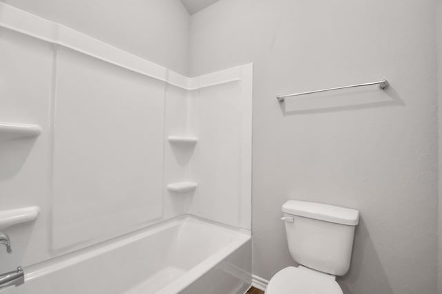 bathroom featuring shower / bathing tub combination and toilet