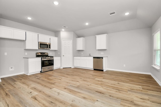 kitchen with appliances with stainless steel finishes, recessed lighting, white cabinetry, and visible vents