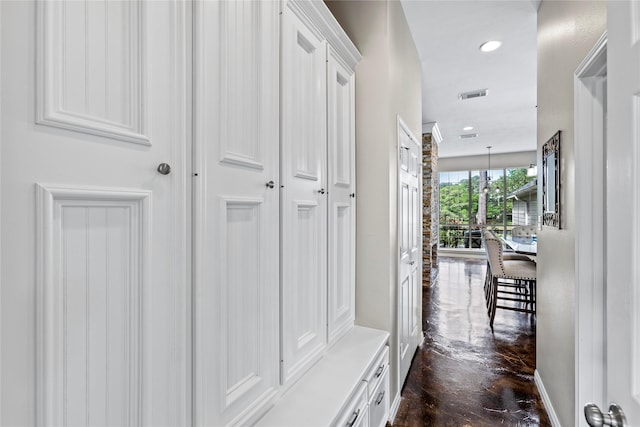 hall with recessed lighting, visible vents, and baseboards