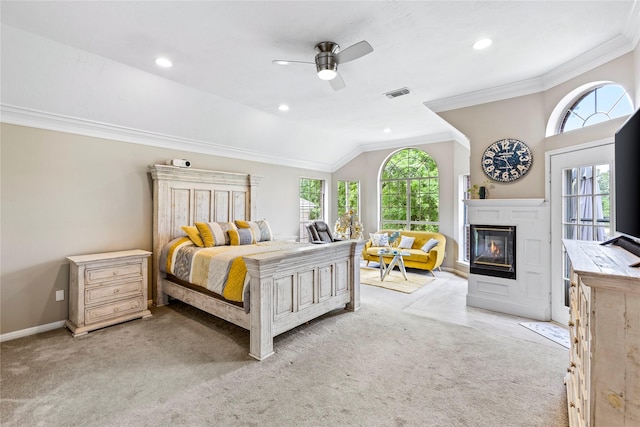 bedroom featuring lofted ceiling, multiple windows, visible vents, and ornamental molding