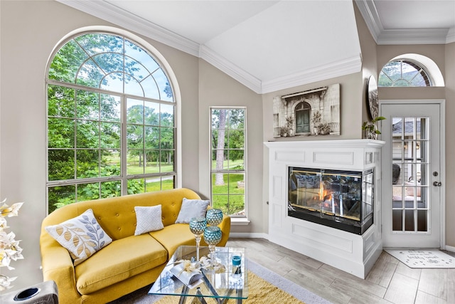 interior space with a glass covered fireplace and vaulted ceiling