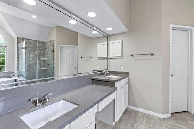 bathroom featuring recessed lighting, vanity, baseboards, vaulted ceiling, and a shower stall