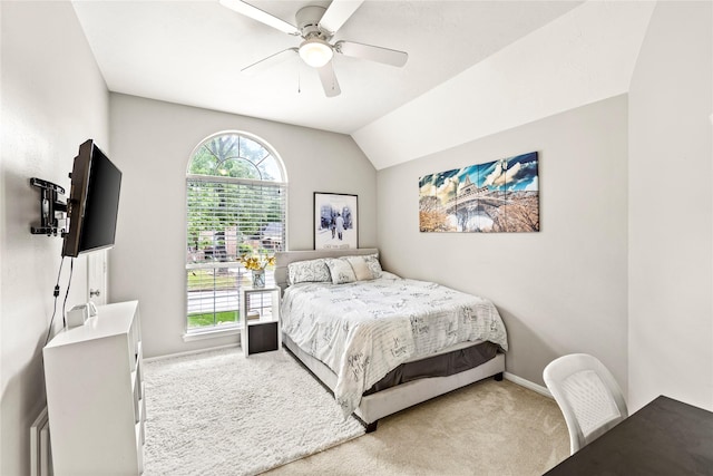 bedroom featuring lofted ceiling, carpet floors, multiple windows, and baseboards