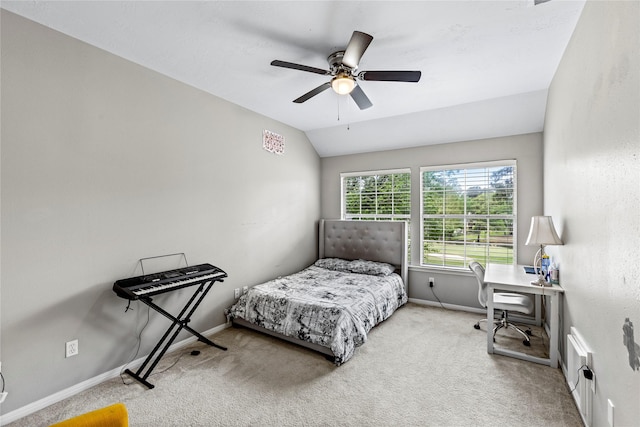 carpeted bedroom with ceiling fan, baseboards, and vaulted ceiling