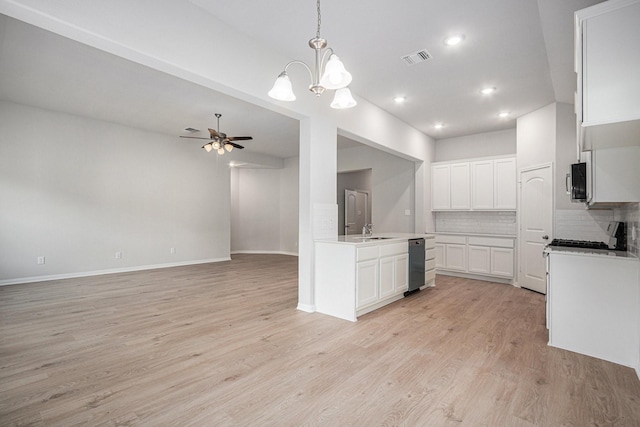 314 Wellshire Dr, West Columbia, TX 77486 - kitchen with tasteful backsplash, light wood-style floors, open floor plan, a chandelier, and white cabinetry