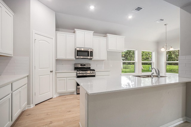 314 Wellshire Dr, West Columbia, TX 77486 - kitchen featuring stainless steel appliances, backsplash, light wood-style flooring, white cabinets, and recessed lighting
