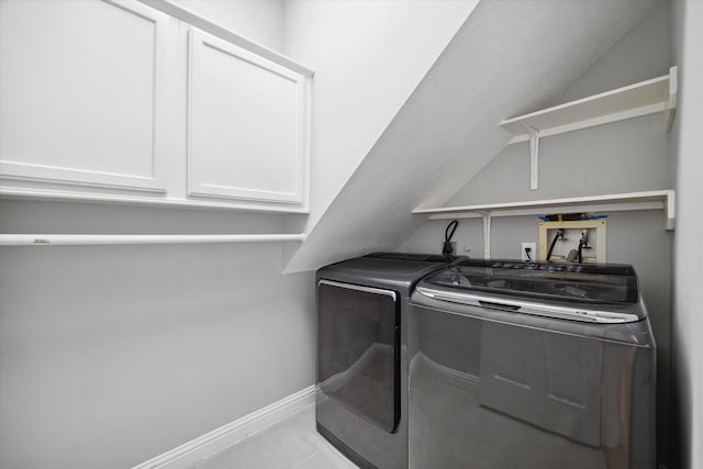 washroom featuring cabinet space, light tile patterned flooring, baseboards, and independent washer and dryer