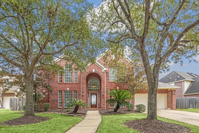 traditional-style home featuring fence, a front lawn, and brick siding