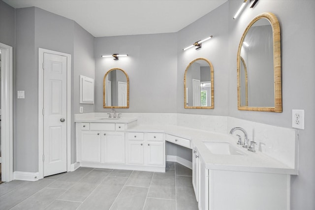 bathroom with double vanity, a sink, and tile patterned floors