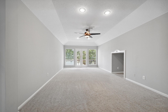 carpeted empty room with a ceiling fan, visible vents, a textured ceiling, and baseboards