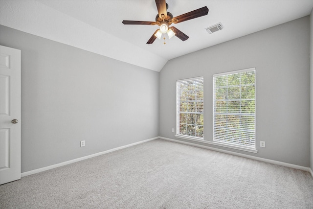 empty room featuring a ceiling fan, carpet, visible vents, and baseboards