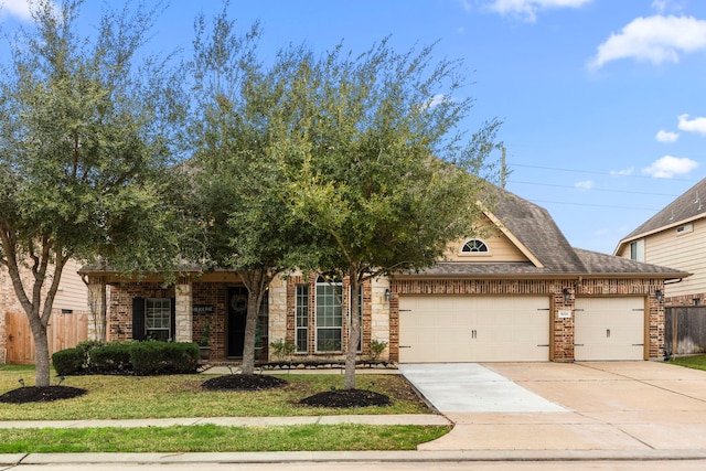 view of front of house featuring a garage, roof with shingles, driveway, and fence